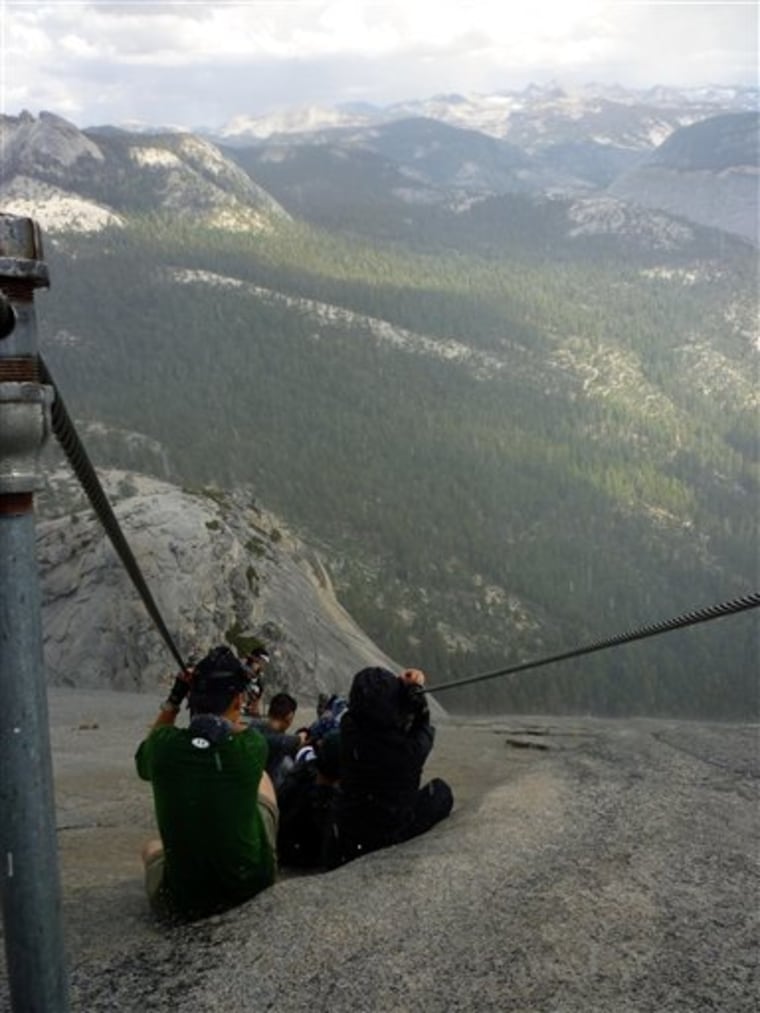 In this Sept. 24 photo provided by Armando Castillo, hikers descend Half Dome in Yosemite National Park. Armando Castillo knew he should not attempt the last treacherous stretch up Half Dome with storm clouds looming. But he felt he had come too far not to accomplish his goal. 